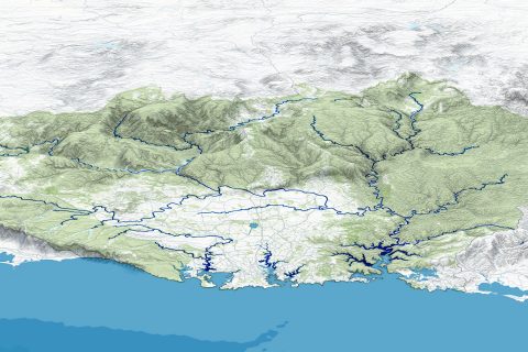 A detailed topographic map shows a mountainous region near the Sydney 2070 mega city, with a network of rivers and water bodies. The terrain is shaded to highlight elevation changes, with green indicating lower altitudes and white representing higher altitudes. A future mega park dots the coastline at the bottom.