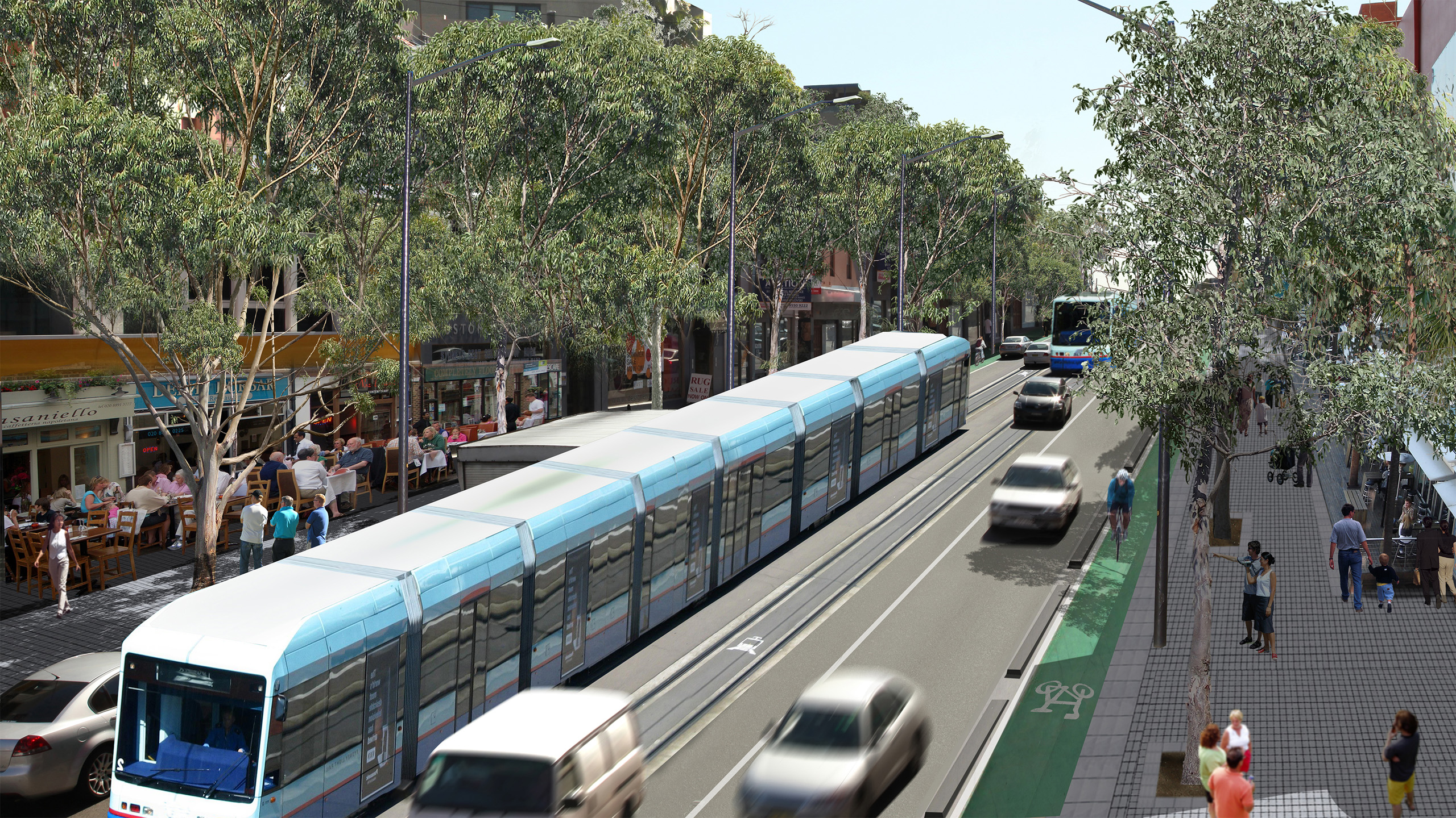 A modern light rail train travels down a tree-lined city street, flanked by moving cars on Parramatta Road and a dedicated bike lane. Pedestrians walk on wide sidewalks, with outdoor dining on the left. The scene is vibrant and sunny, reflecting urban public transportation and community life.