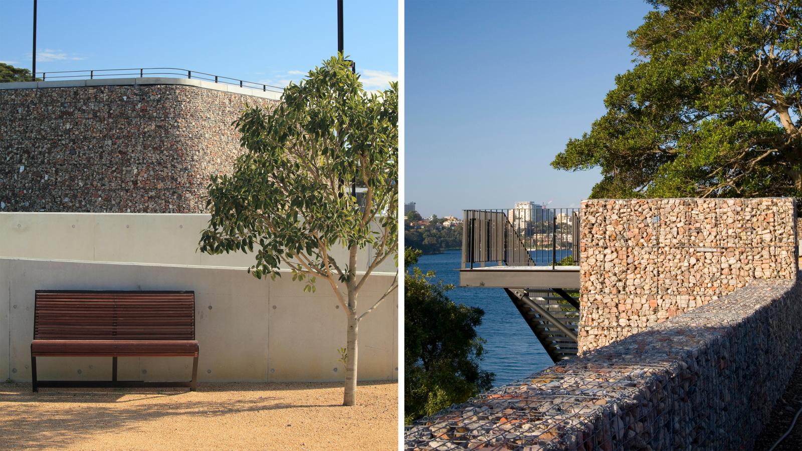Split image: left side shows a park bench next to a tree, backed by a rock-filled wire retaining wall under a clear sky in Ballast Point Park; right side shows a different angle of the same type of wall stretching towards a body of water, with city buildings visible in the distance.