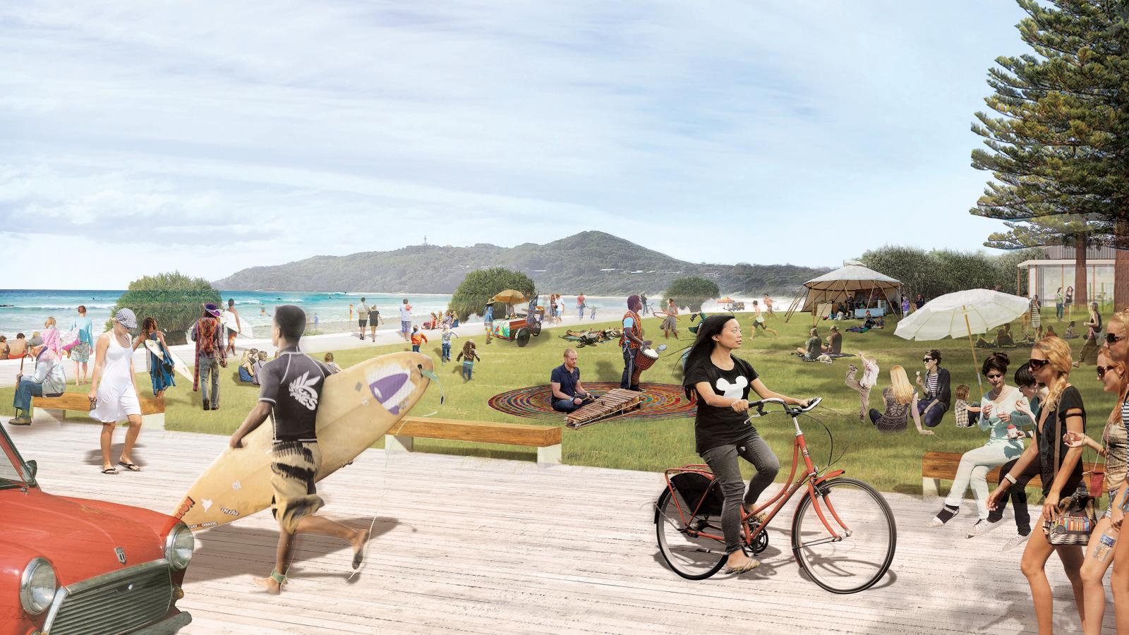 A lively beach scene at Byron Bay with people engaging in various activities. A person rides a bike on a boardwalk, others carry surfboards, and groups sit on the grass playing music or relaxing. The background features a sandy beach, ocean waves, and a tree-covered hill, all part of the master plan for this scenic locale.