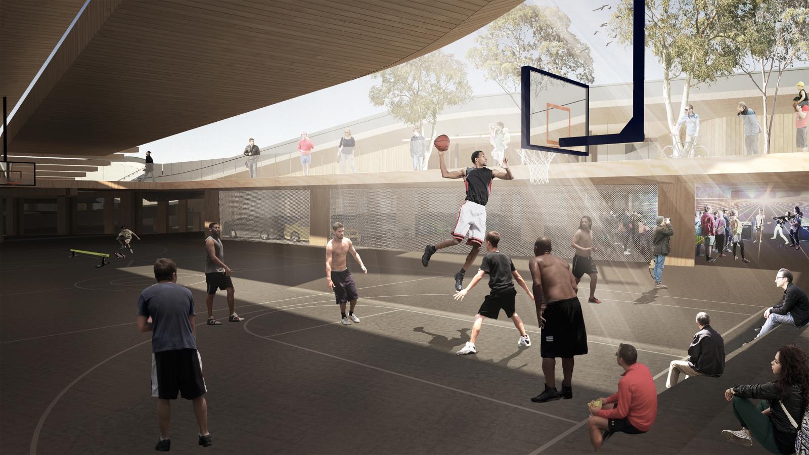 A group of people are playing basketball on an outdoor court under a covered pavilion near Cato St. One player is mid-air, about to dunk the ball. Spectators are watching from a raised platform in the background. Tree foliage and a clear sky are visible beyond the structure and adjacent car park.