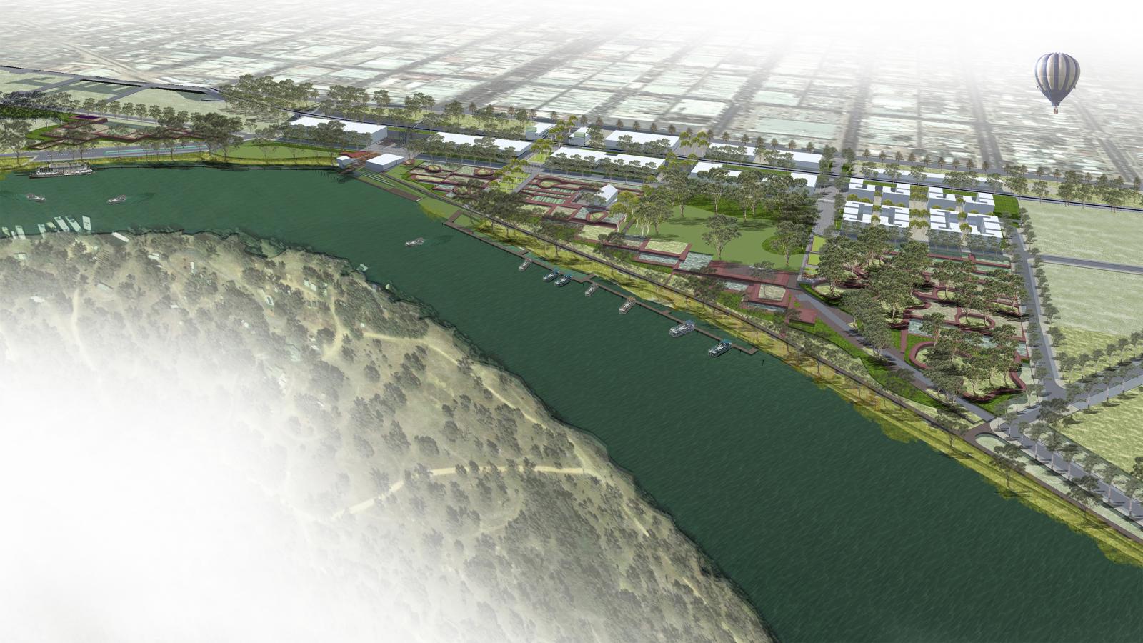 Aerial view of a master plan showcasing Mildura's green urban development along the riverfront. The landscape features parks, pathways, residential and commercial buildings. Trees and greenery dominate the area, and a hot air balloon can be seen in the distance.