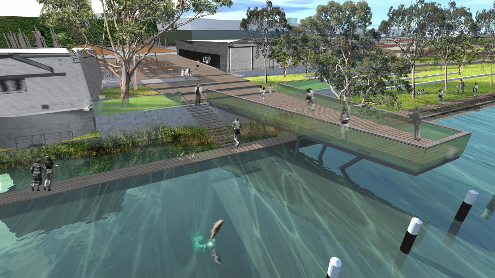 A modern waterfront scene at Riverfront Mildura features a wooden boardwalk extending over a calm body of water. People are seen walking and sitting along the boardwalk, with buildings and greenery in the background. A person is swimming near the boardwalk’s edge while others observe.