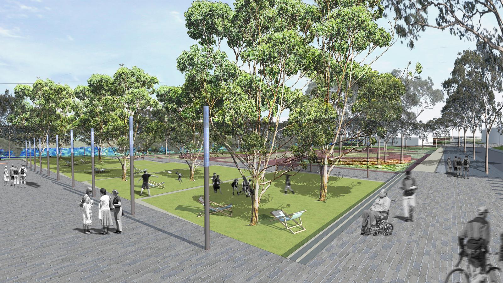 A spacious outdoor park scene with green lawns, tall trees, and scattered benches lines the Mildura riverfront. People are leisurely walking and sitting. Some are in groups, while others are alone. There is a path alongside the park with a person on a bicycle and another in a wheelchair.