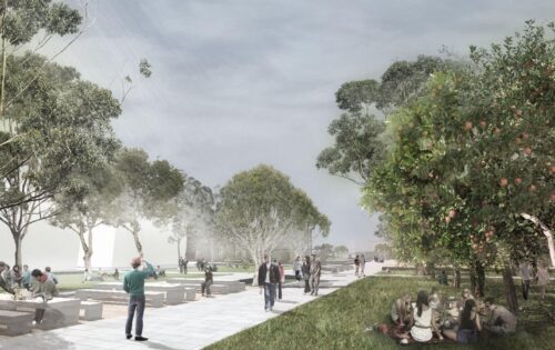 A green park scene in the Central Precinct with people walking, sitting on benches, and gathering on the grass. Pathway lined with trees on either side. Some people are taking photos, while others are relaxing. The sky is overcast with light filtering through the clouds—a true revitalisation of urban space.