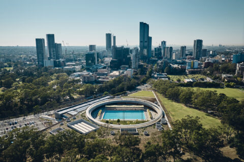 Aerial view of Parramatta Aquatic Centre with a background of the Parramatta skyline.