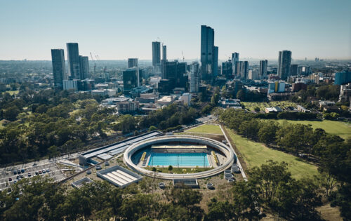 Aerial view of Parramatta Aquatic Centre with a background of the Parramatta skyline.