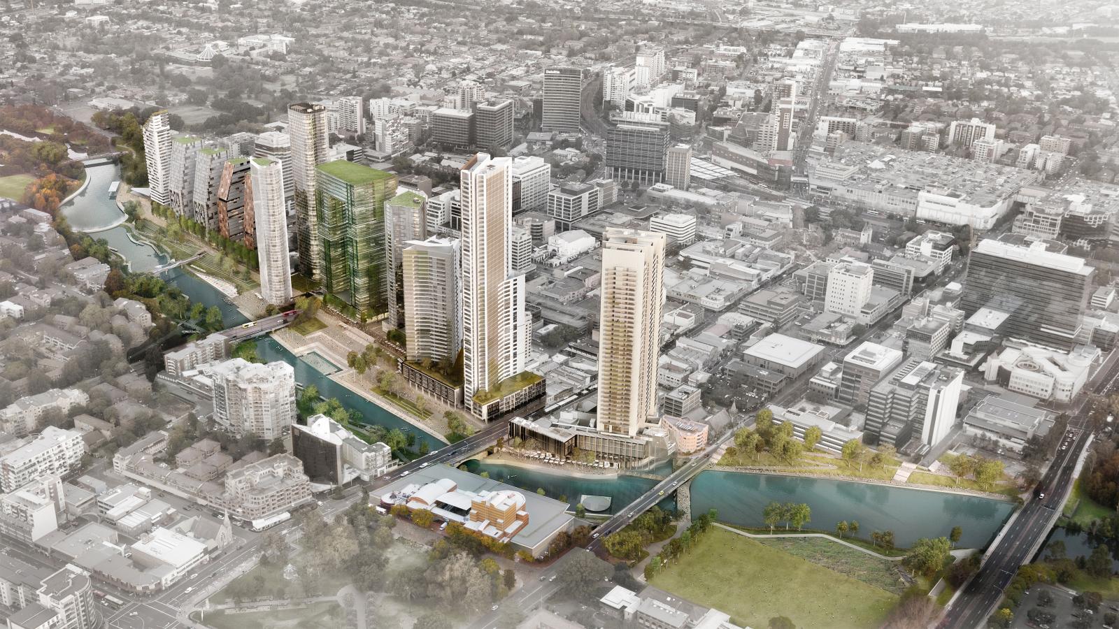 An aerial view of Parramatta showcases a vibrant cityscape featuring a mix of tall and mid-rise buildings clustered around the river that winds through the urban area. Bridges cross the river, connecting different parts of the city, while parks with green spaces and trees are visible throughout.