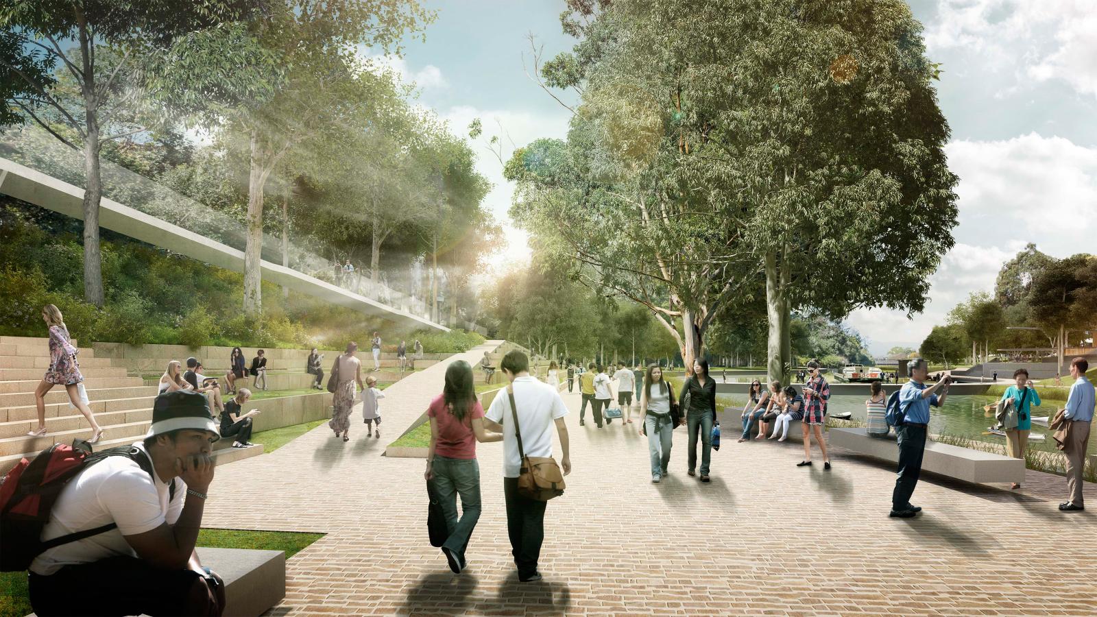 A bustling urban park in Parramatta with people walking, sitting on steps, and relaxing on benches. Tall trees provide shade along a wide pathway as part of the River Plan. Some people engage in conversation, while others enjoy the serene environment. The sun shines brightly through the trees.