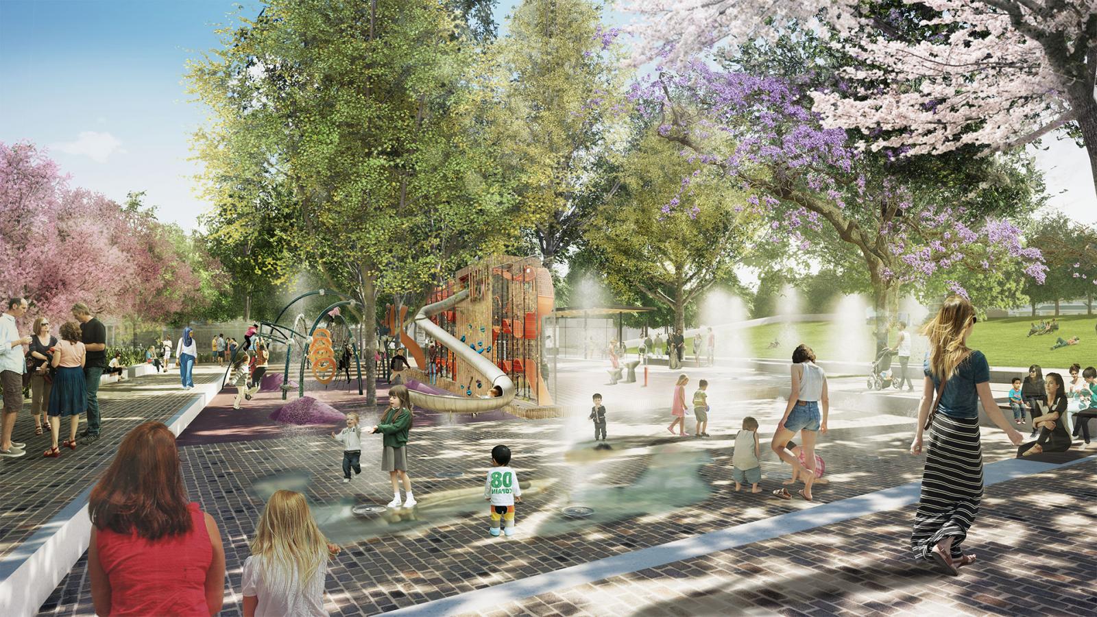 A vibrant scene unfolds at Paul Keating Park, with children and adults enjoying various activities. Kids play on a colorful playground structure with slides, while others splash in a nearby water feature. Trees with pink blossoms and green leaves provide shade as people sit and walk around the area.