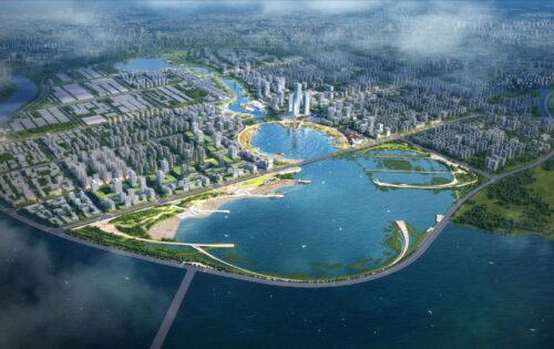 Aerial view of an expansive urban area in Qingdao, surrounded by water. The city features numerous buildings, tall skyscrapers, and lush green spaces. Prominent bodies of water include Ruyi Lake within the city and surrounding rivers with various bridges.