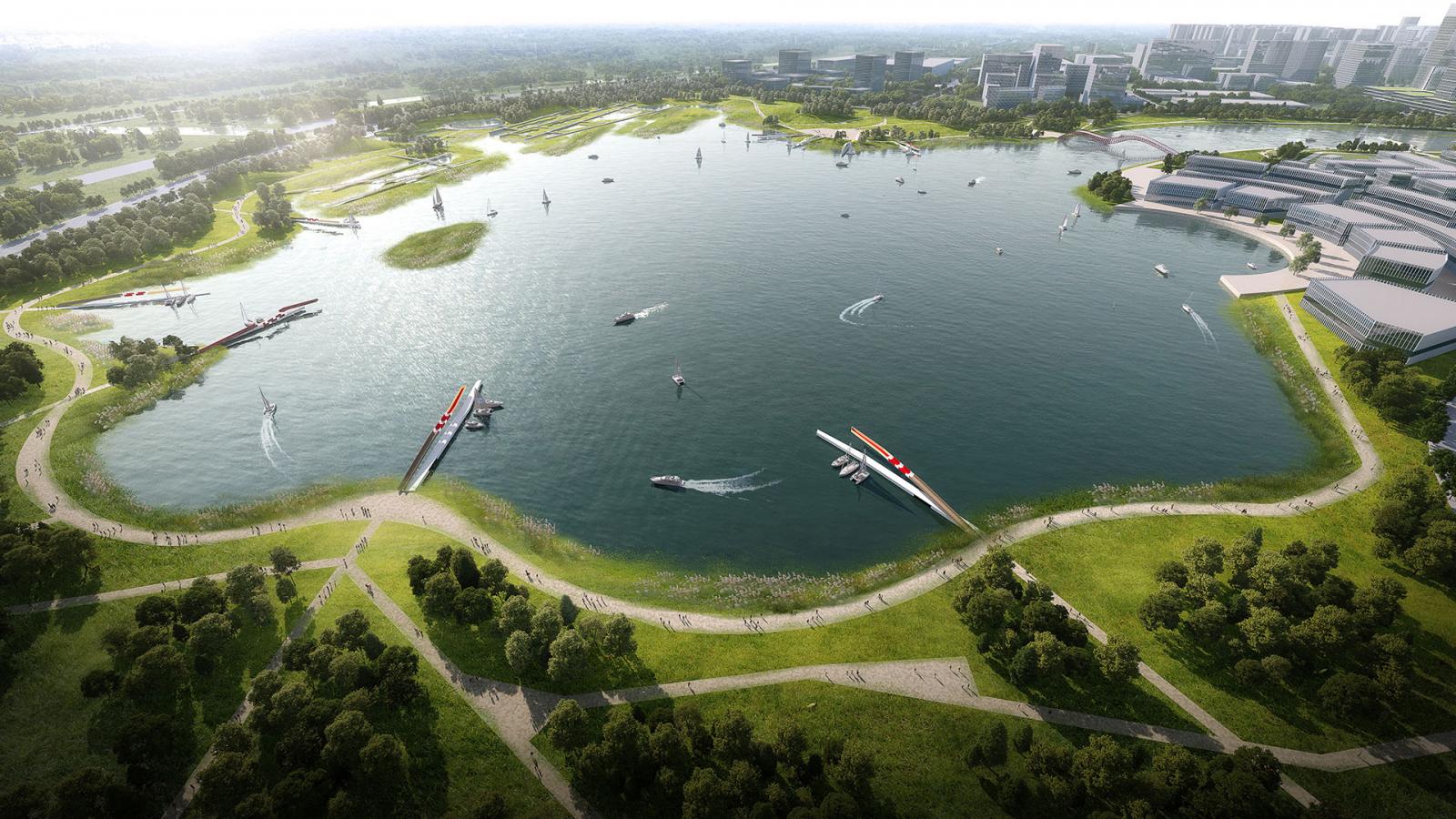 Aerial view of serene Ruyi Lake surrounded by lush greenery and walking paths in Qingdao. Several boats, possibly in a competition, sail on the water with docks extending into the lake. Modern buildings are visible on the right side, blending harmoniously with the natural landscape.