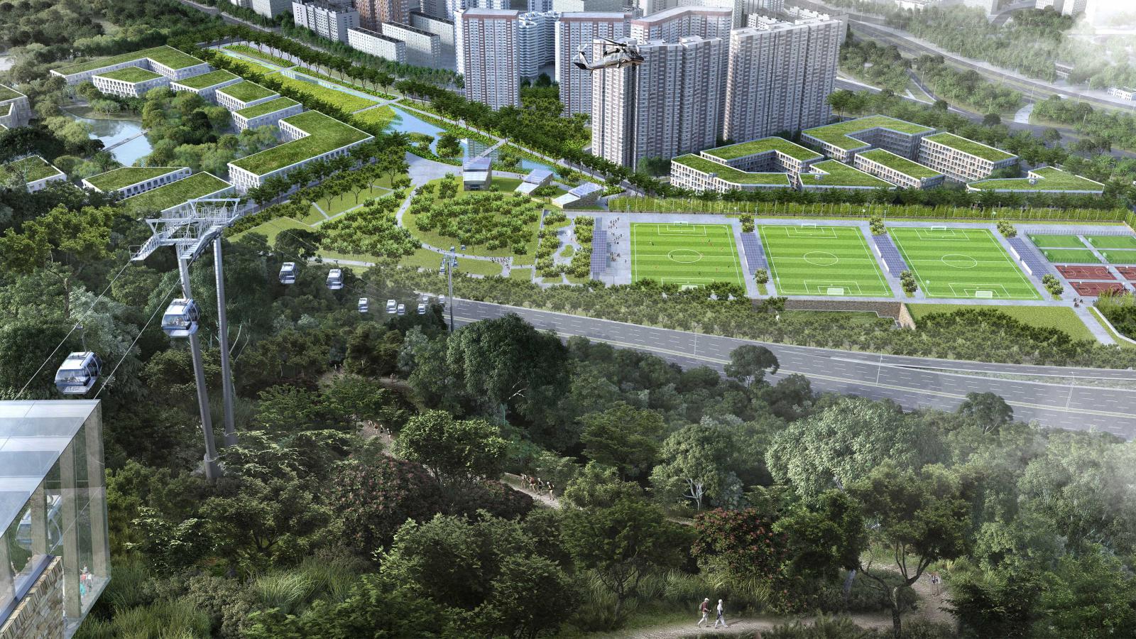 Aerial view of Shenzhen's sprawling urban landscape featuring high-rise buildings, multiple sports fields, lush greenery, and a cable car system. The scene also includes a well-maintained road and trees spread across the area, with Danaoke Mountain majestically rising in the background.