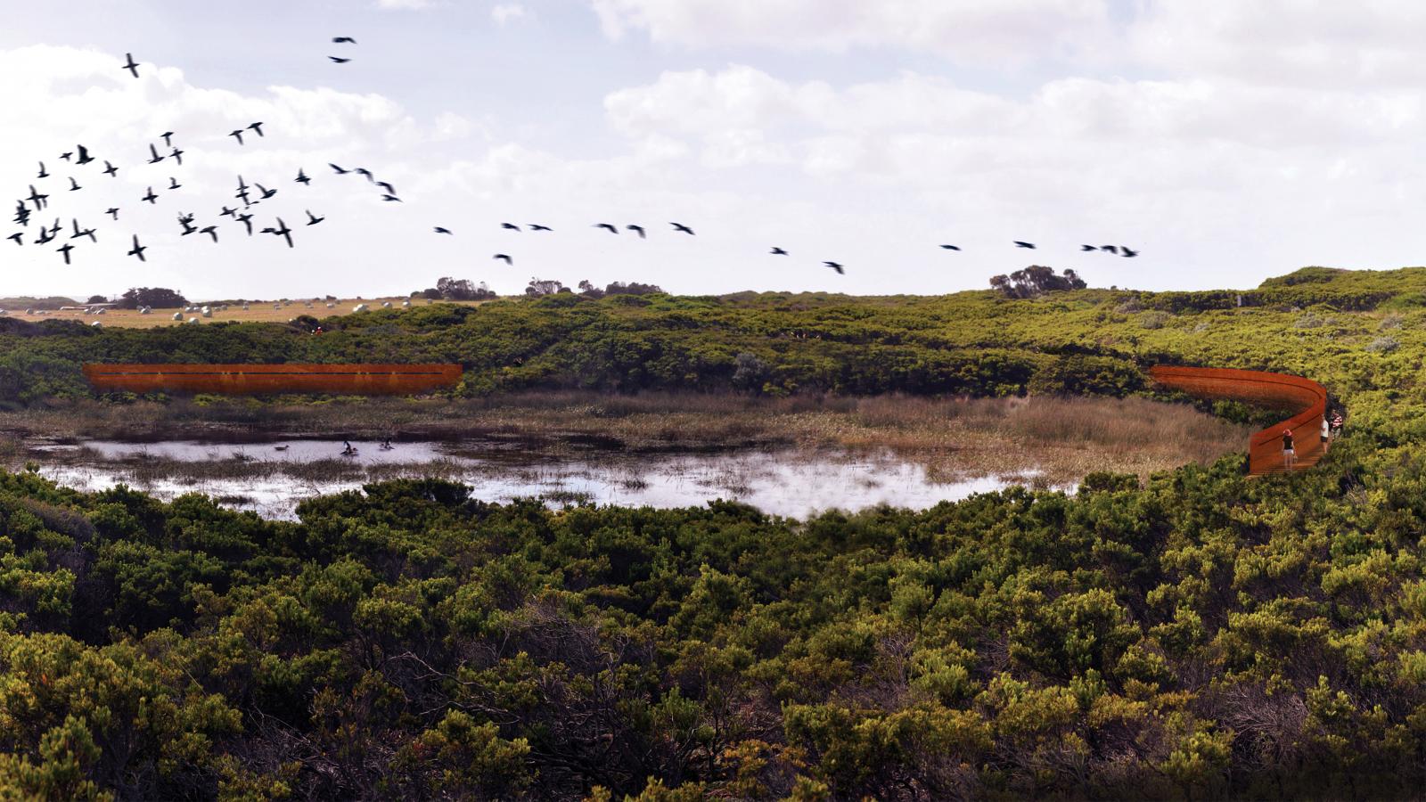 A lush green landscape features a large wetland with a wooden boardwalk curving around the area, reminiscent of the tranquil beauty found along the Shipwreck Coast. Birds are flying overhead in a V formation, and the sky is partly cloudy. The dense vegetation surrounds the wetland, creating a serene and natural environment.