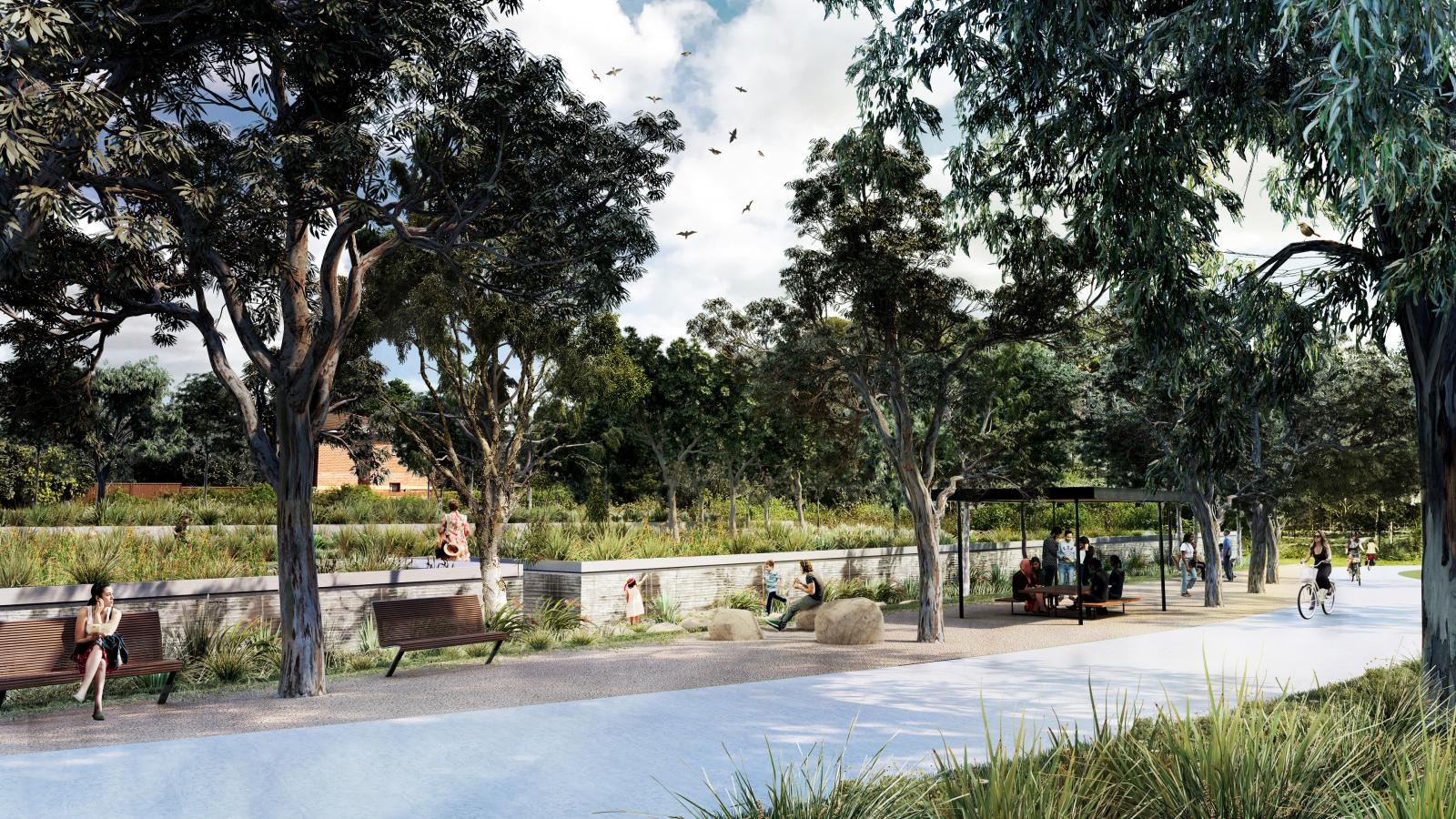 A park scene in Sydney features a paved pathway, benches, and people sitting and walking. Tall trees provide shade, and greenery lines the pathway. Birds fly in a partly cloudy sky as some individuals rest while a cyclist rides along the path near shimmering water.