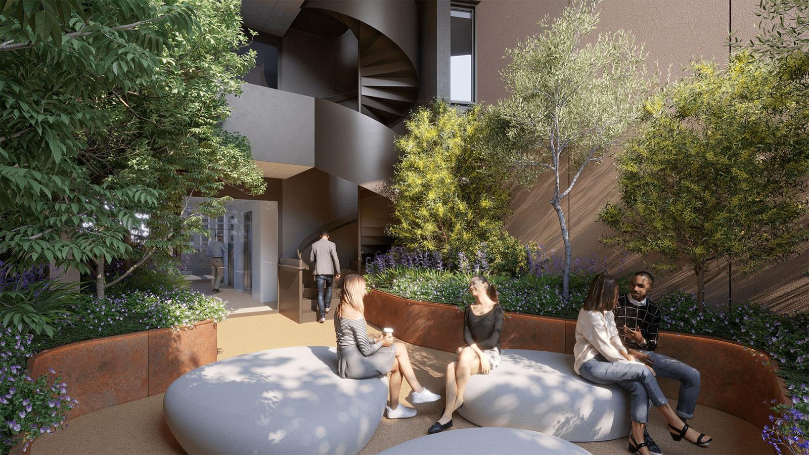 An outdoor seating area at Ivanhoe Estate showcases people chatting on large, cushion-like benches surrounded by greenery and trees. A spiral staircase resembling a treehouse in the background leads up to a doorway. The setting appears modern and relaxing.