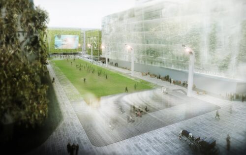 An urban park scene with a central green lawn surrounded by walkways and modern buildings. People are scattered across the grass and pathways. The scene is illuminated by streetlights, and in the background, there's a large digital screen displaying images from UTS alumni events.