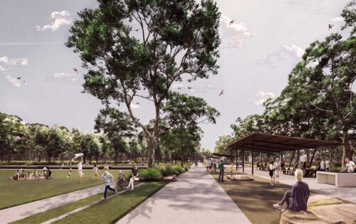 A spacious park scene with people enjoying various activities. On the left, individuals are sitting on grass and flying kites. The right features paved walkways, trees, and a covered area with benches. The sky is partly cloudy, and the atmosphere is serene and lively at Whittlesea Gardens.