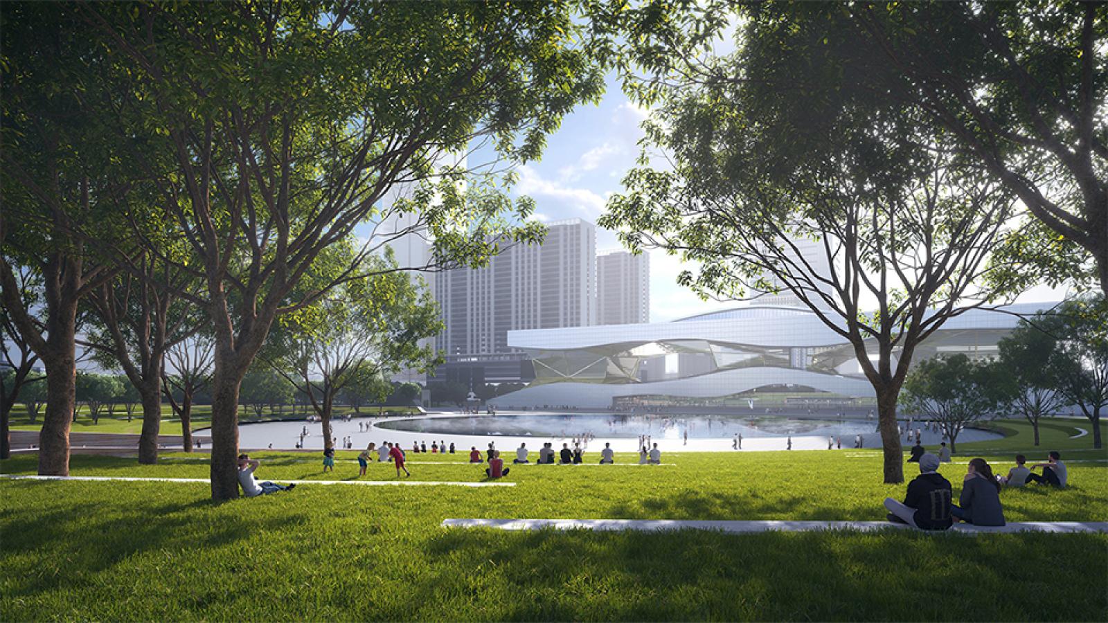 People relax on a grassy lawn surrounded by trees in a modern urban park. In the background, a large, futuristic white building with flowing lines stands near a pond, with tall buildings visible behind it. This tranquil spot is part of Taihu Plaza in Wuxi.