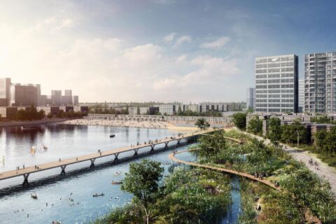 A scenic riverside city view with a pedestrian bridge spanning across the water. High-rise buildings line the background, while the foreground features lush greenery and winding pathways reminiscent of Xiangmihu Park. People are seen boating, walking, and enjoying the urban landscape in this vibrant Park City.