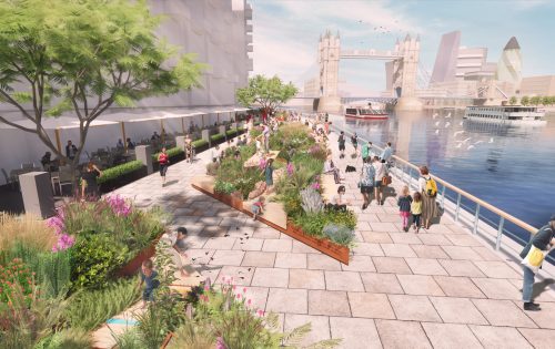 A bustling riverside promenade at Butler's Wharf features people walking, sitting on benches, and dining outdoors under trees and umbrellas. The scene is adorned with lush flower beds. Tower Bridge stands in the background over the river, where boats and birds are visible.