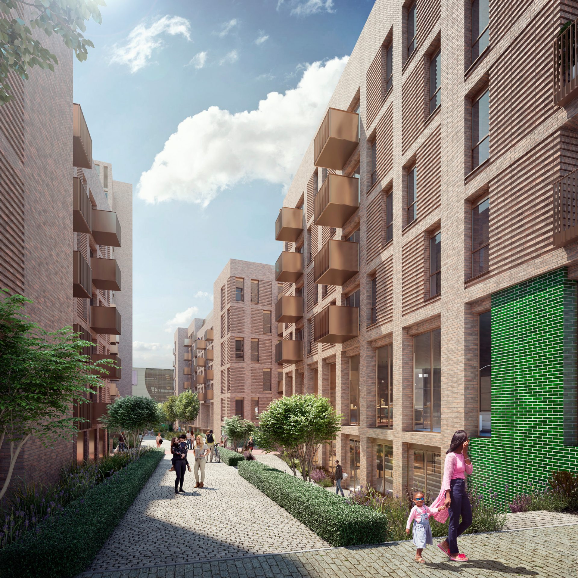 A modern urban pathway, known as Station Place, lined with multi-story brick buildings featuring large windows and balconies. People walk along the path, including a woman holding a child's hand. Trees and greenery adorn the area, and the sky is bright with scattered clouds.