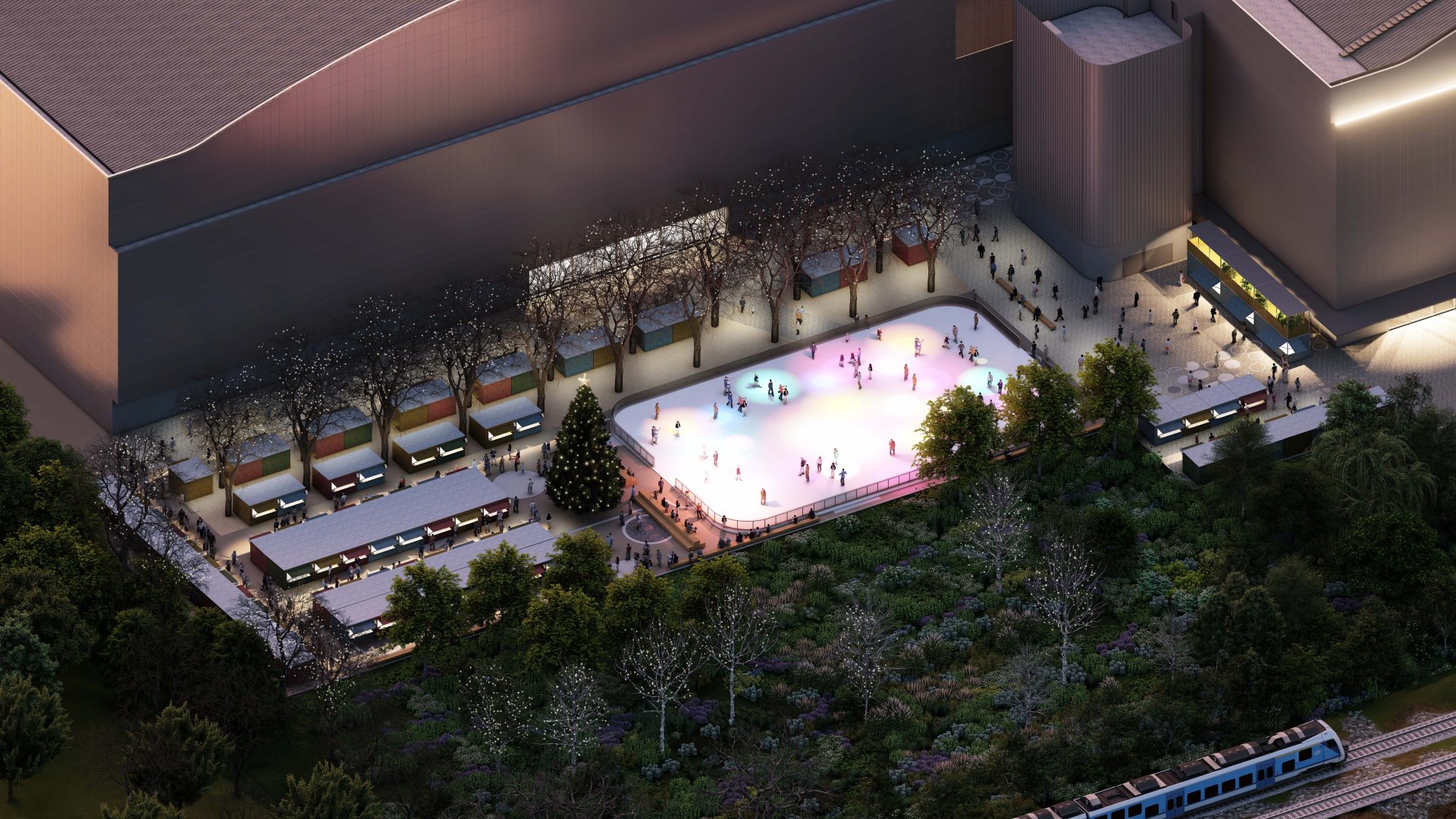 An aerial view of a brightly lit outdoor ice skating rink at YTL Arena with numerous people skating. The rink is surrounded by festive decorations, including a large Christmas tree and illuminated trees. There are several small structures nearby and a train visible in the lower right corner.