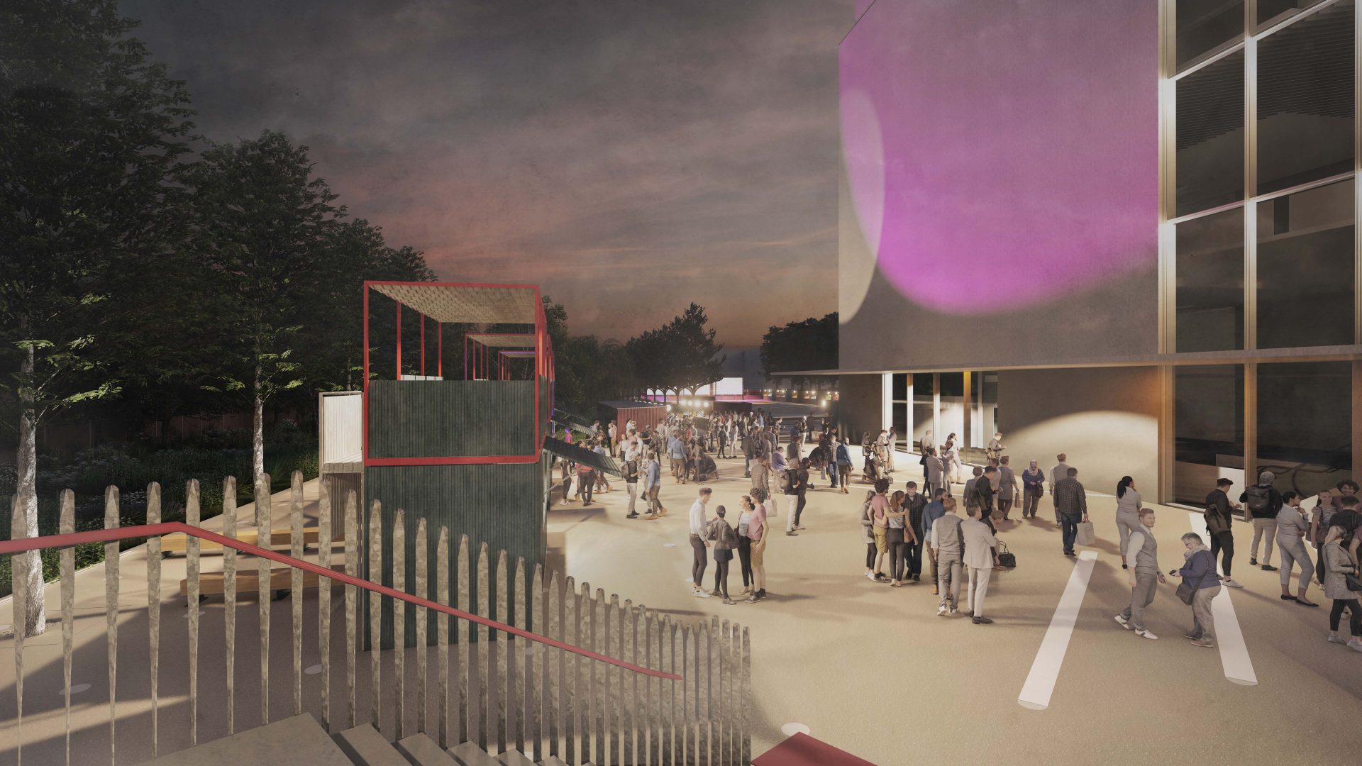 A bustling outdoor night scene with people socializing near YTL Arena. The area is lit with soft pink, purple, and yellow lights. A set of stairs, seating areas, and trees are visible, creating a vibrant atmosphere perfect for events.