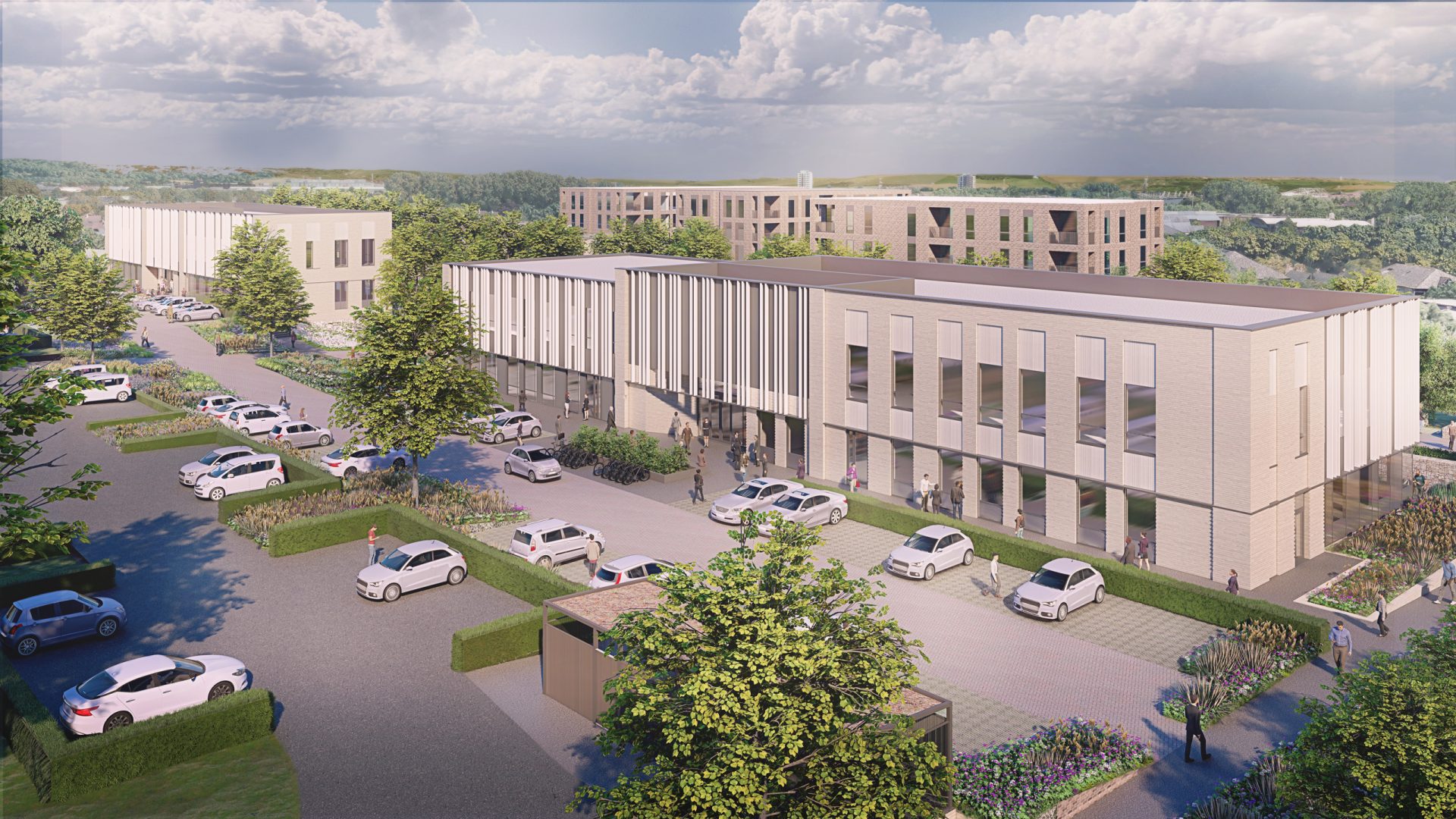 A modern office complex in Oxford features multiple rectangular buildings with large windows and flat roofs. The scene includes landscaped areas with trees and parked cars lining the pathways, blending innovation with natural beauty. The sky is partly cloudy, and the background reveals more buildings and greenery.