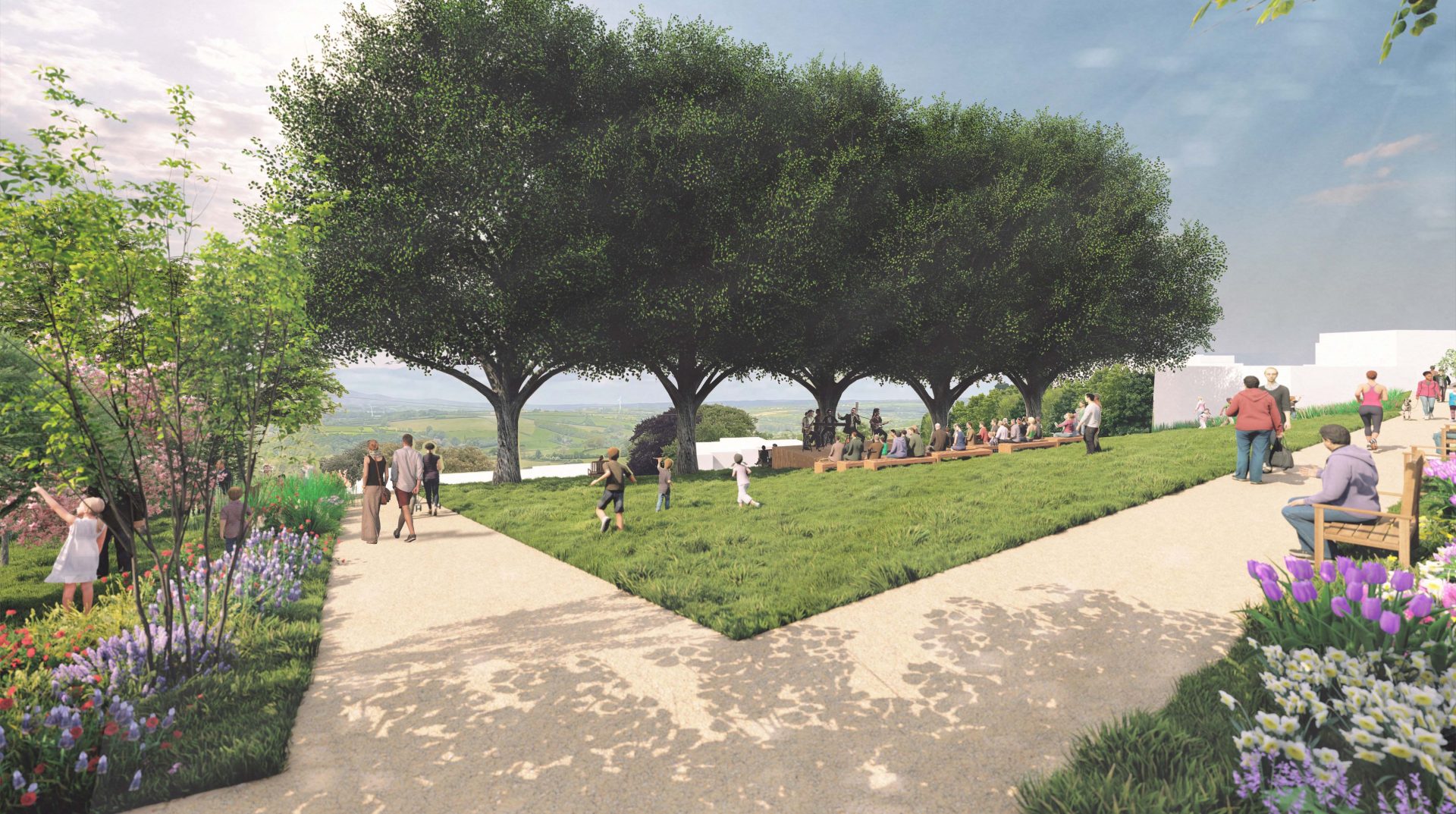 A landscaped garden in Launceston features a grassy area with people sitting under a row of trees in the background. Pathways surround the lawn, bordered by colorful flowers and shrubs. Visitors stroll, sit on benches, and appreciate the scenic, sunny setting, contributing to greener streets in the city.