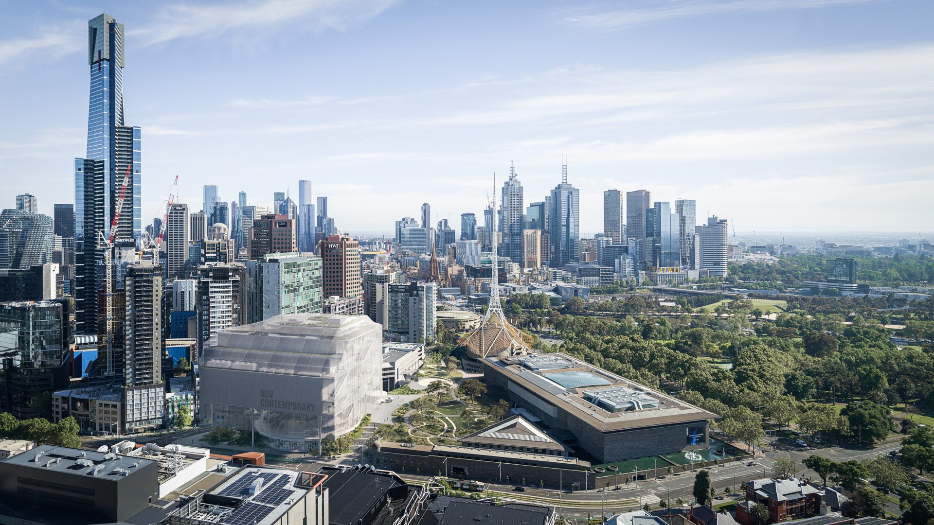 Aerial view of the Melbourne cityscape with numerous high-rise buildings, including a prominent skyscraper with a dark exterior, surrounded by lush green parks and open spaces. The skyline extends into the horizon under a partly cloudy sky, near the renowned National Gallery of Victoria.