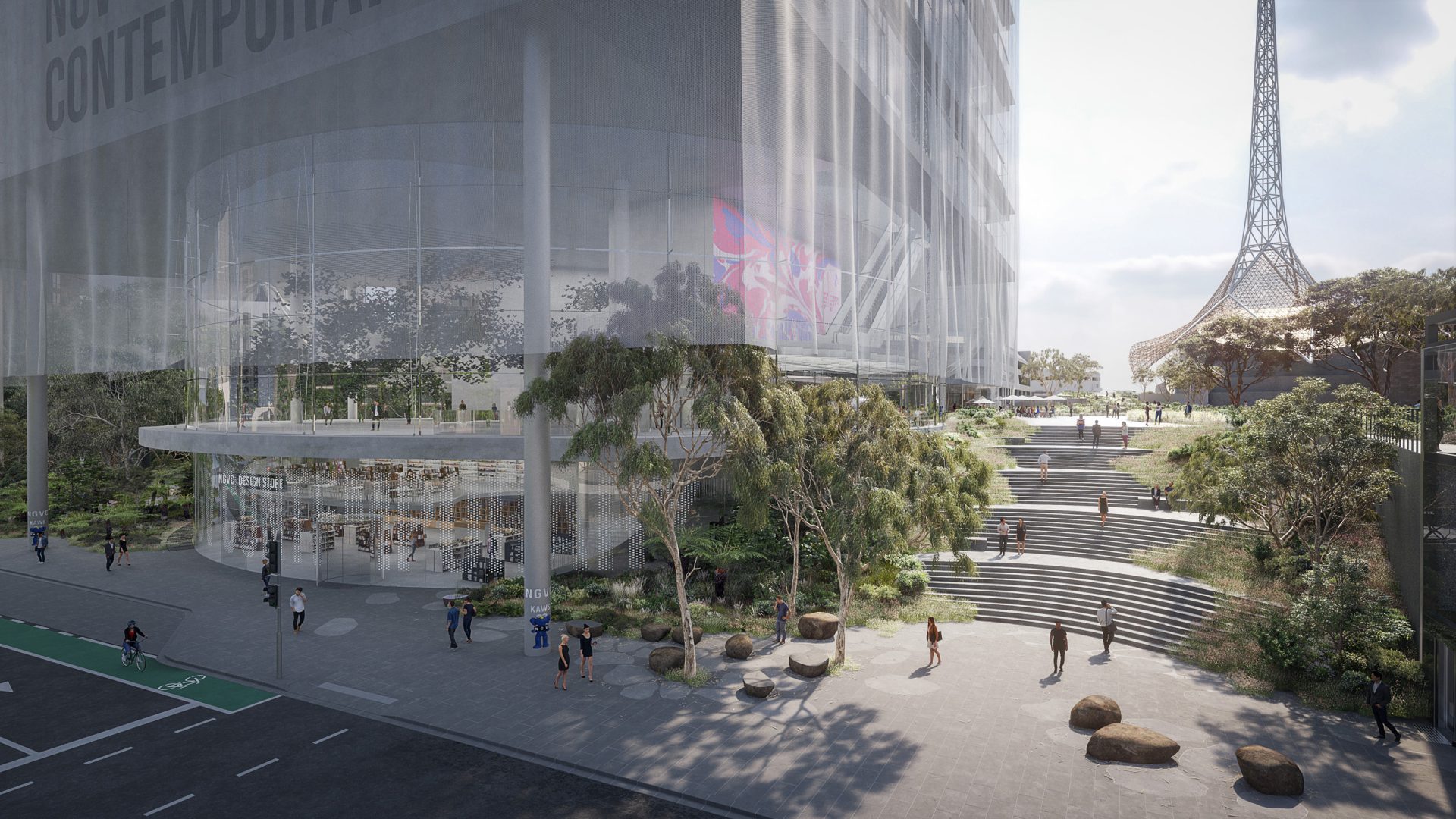 A modern, multi-story building with a glass facade and a large, open space with greenery and steps leading to it. People walk and gather outside the National Gallery of Victoria. To the right, a tall, slender tower can be seen in the distance. Trees and rocks decorate the landscape in this contemporary competition setting.